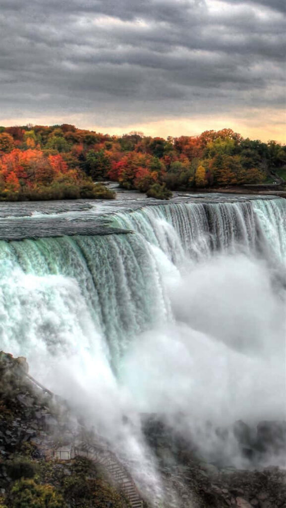 Breathtaking Niagara Falls Wallpaper: Autumn Foliage & Stormy Sky