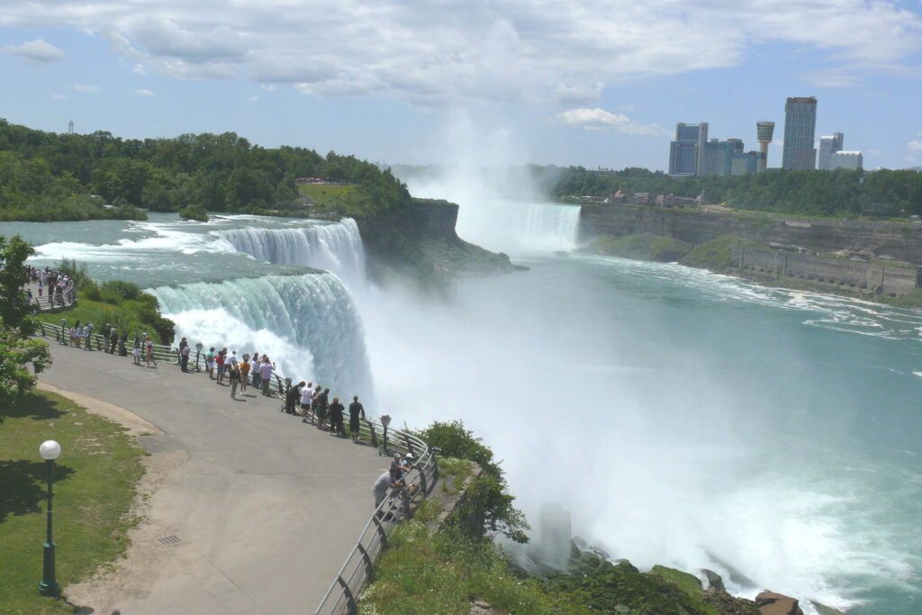 Breathtaking Niagara Falls View: Cascading Waterfalls & Lush Greenery Wallpaper
