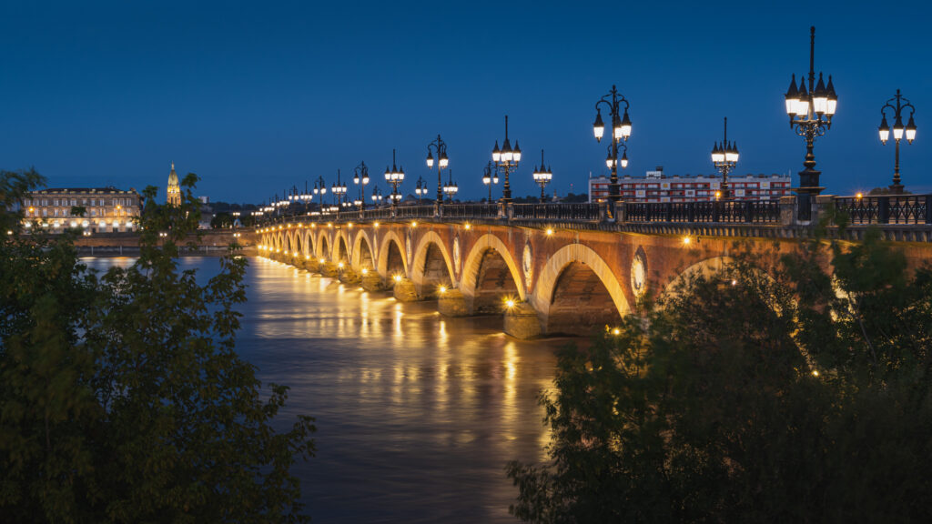 Serene Night Bridge Wallpaper with City Lights Reflection