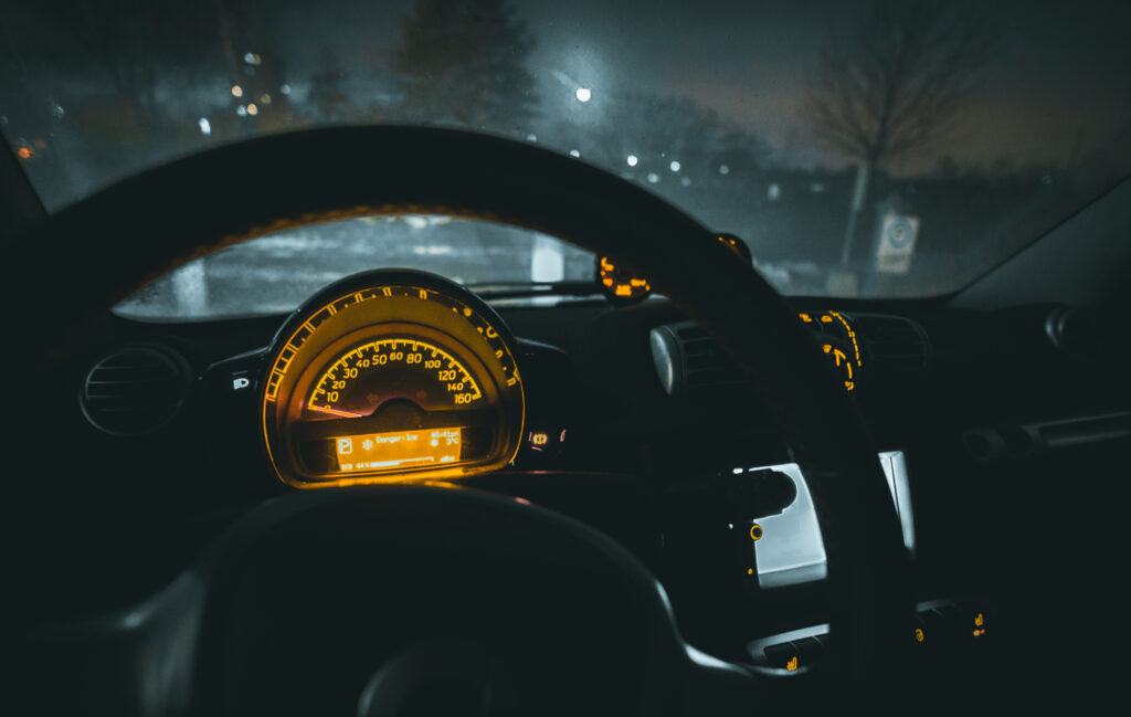 Glowing Car Interior at Night: Sleek Dashboard & Speedometer Lights Wallpaper