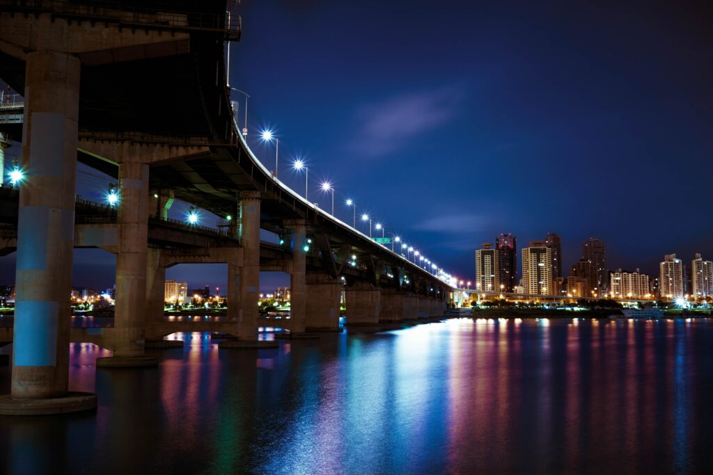 Stunning Night City Wallpaper: Glowing Bridge & Reflective River