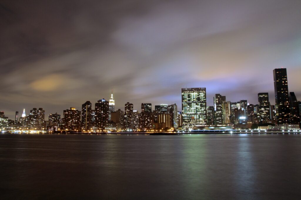 Stunning Night Cityscape Wallpaper: Illuminated Skyline & Water Reflections