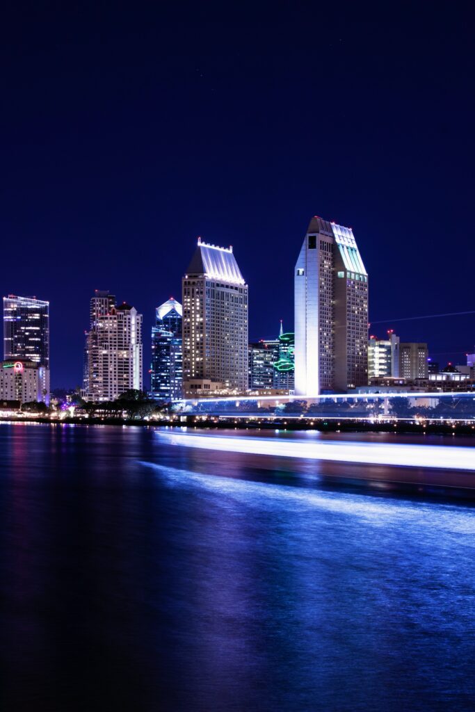 Stunning Night Cityscape Wallpaper with Reflections and Light Trails