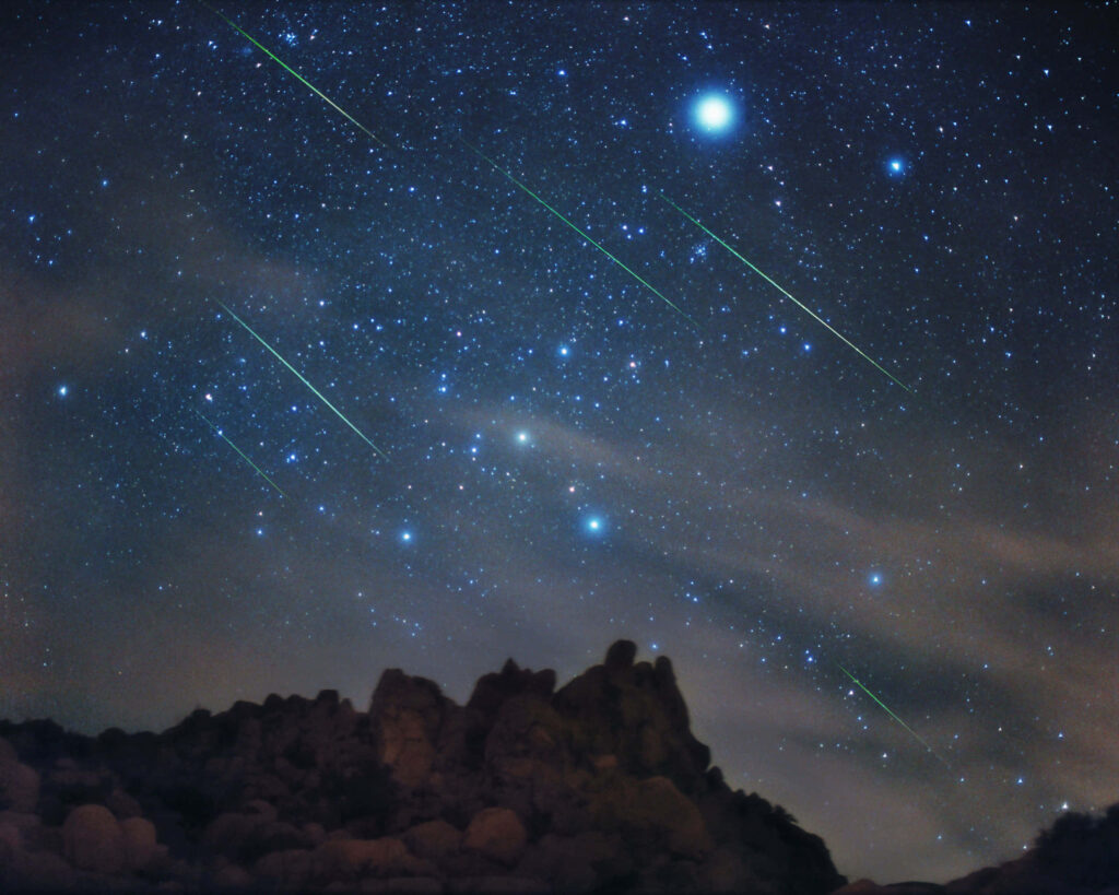 Stunning Meteor Shower Wallpaper: Starry Night Over Rocky Landscape