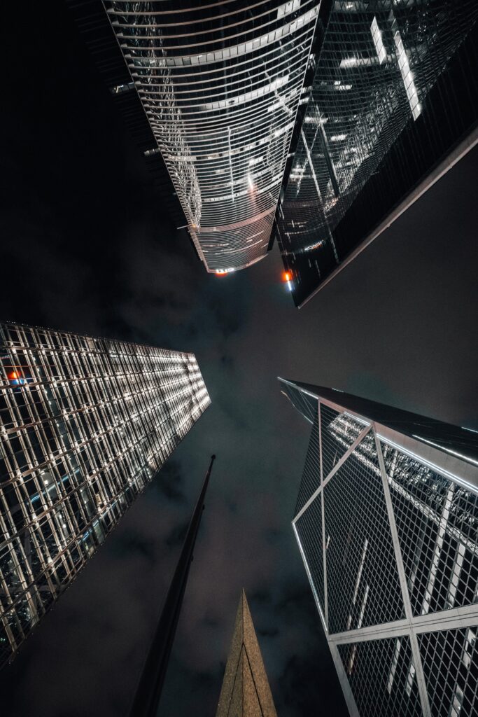 Stunning Night View Wallpaper: Skyscrapers & Cloudy Sky Illuminated