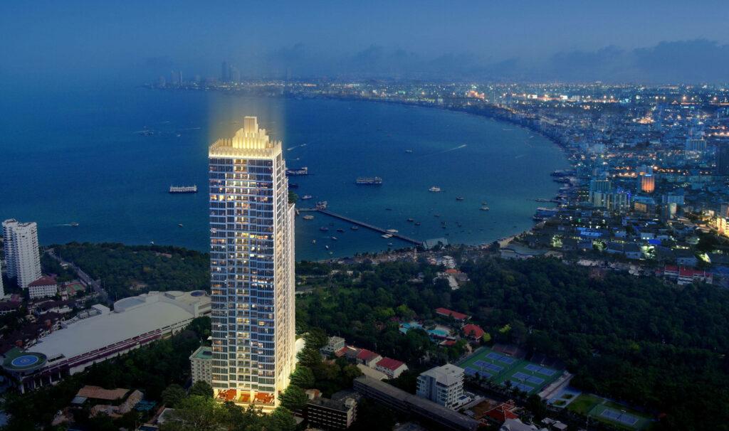 Vibrant Pattaya Night View: Skyscraper & Serene Coastline Wallpaper