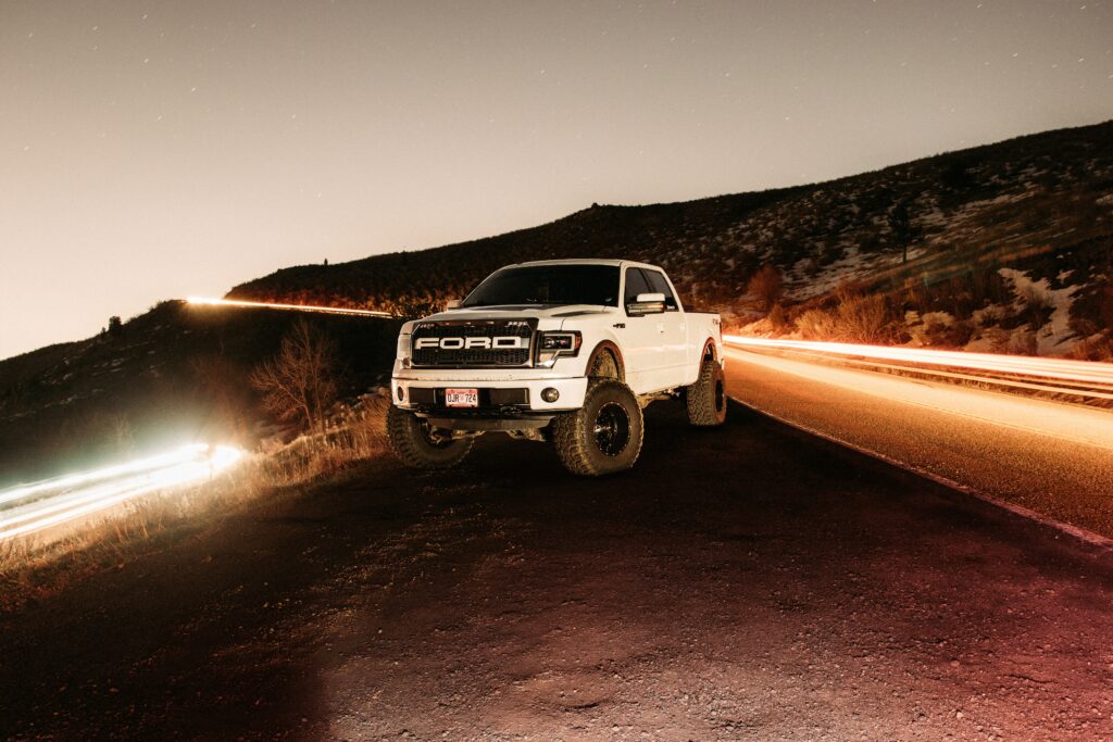 White Ford Raptor Night Wallpaper: Rugged Truck under Starry Sky