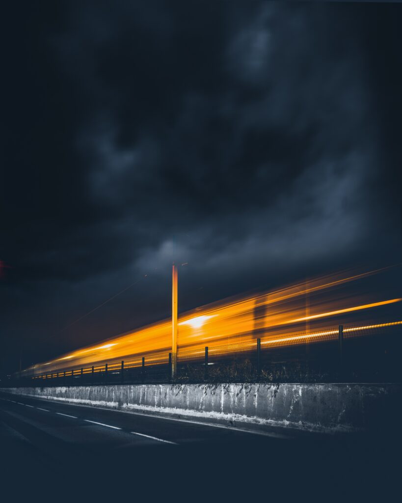 Vibrant Nightscape Wallpaper: Illuminated Road & Dramatic Skies