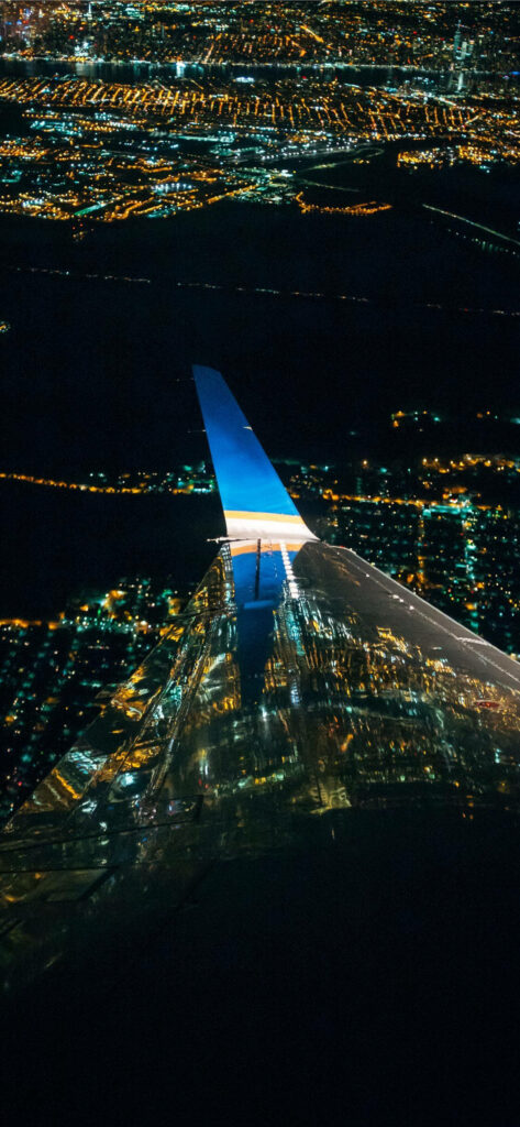 Stunning Nighttime Airplane View: Illuminated Cityscape Wallpaper