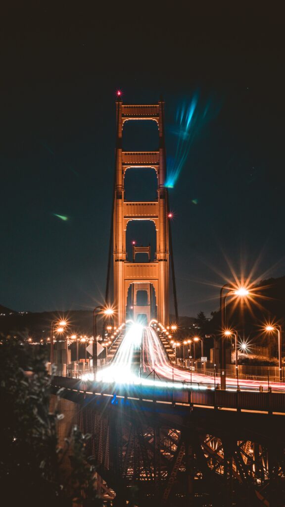 “Stunning Nighttime Bridge Wallpaper with Glowing Lights & Motion Trails”