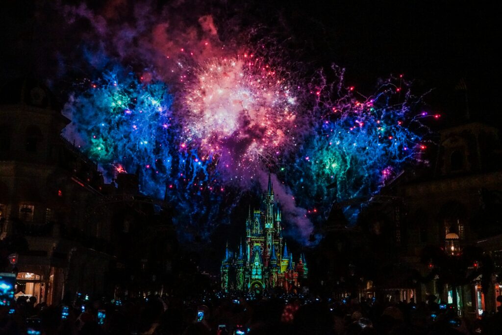 Majestic Castle Night Wallpaper: Festive Fireworks & Colorful Lights