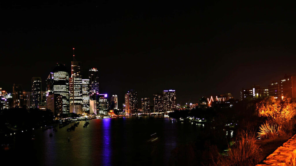Stunning Nighttime Cityscape Wallpaper: Illuminated Skyline Reflection