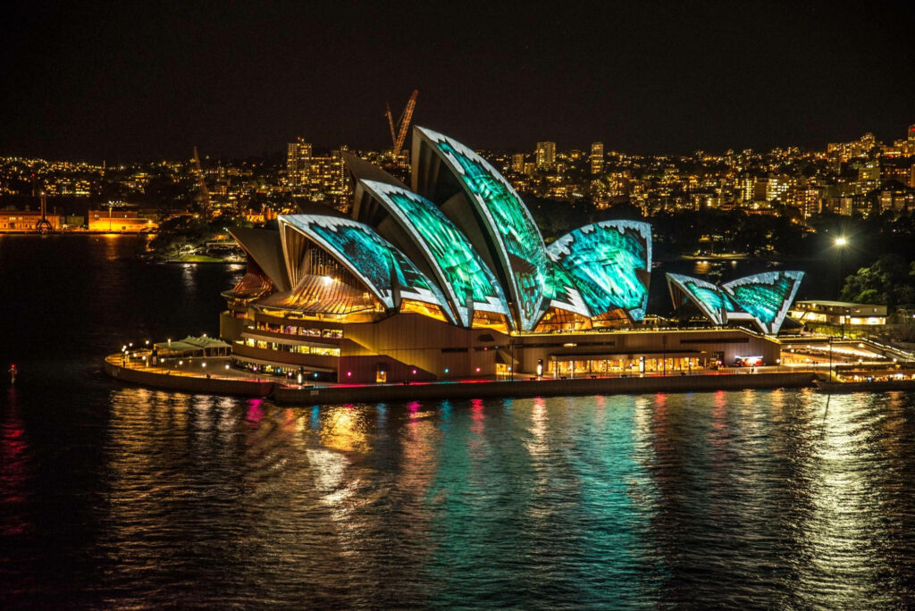 Vibrant Nighttime Sydney Opera House Wallpaper with City Skyline