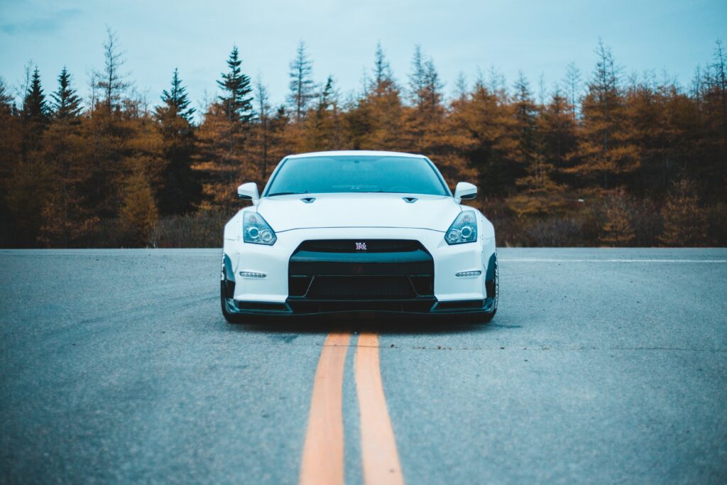 Nissan GT-R Front View Wallpaper: Sleek Car Amid Autumn Trees