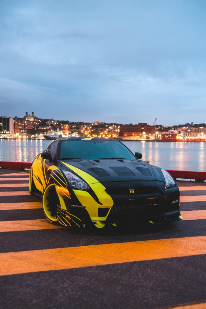 Vibrant Nissan GT-R: Stunning Waterfront Sports Car Wallpaper