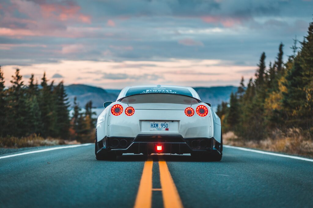 Stunning Nissan GT-R Rear View on Open Road - Dynamic Wallpaper