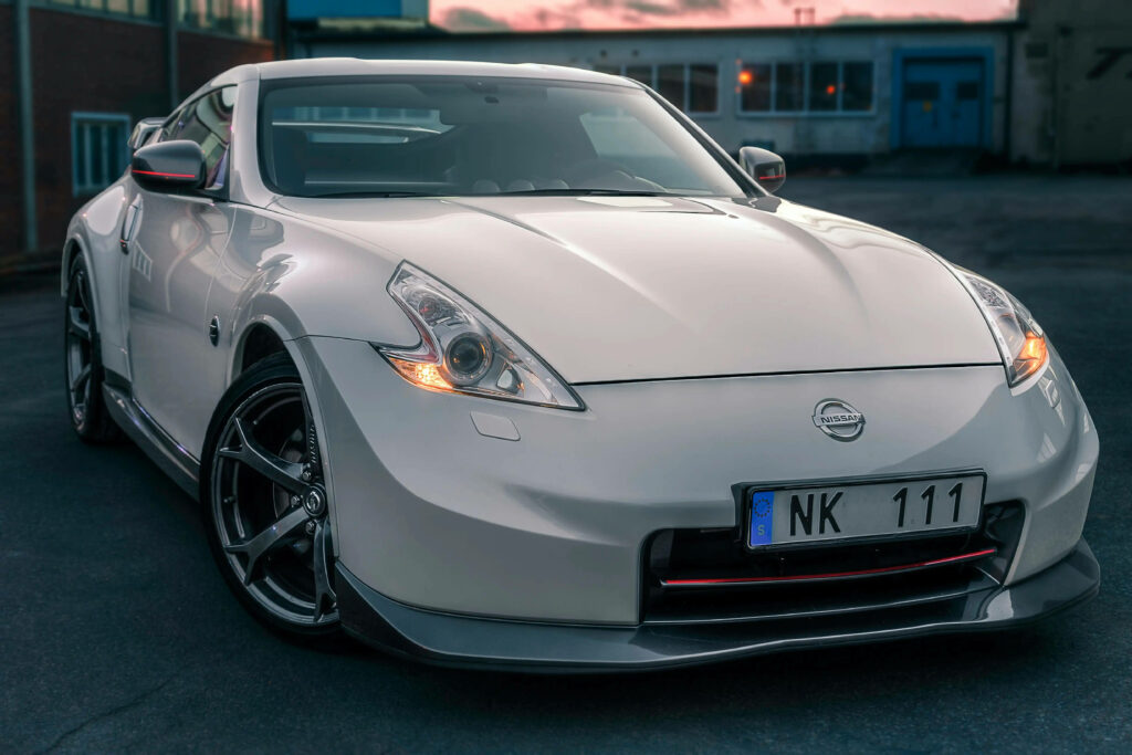 Stunning Nissan GTR Competitor Wallpaper: Sleek Design in Urban Sunset