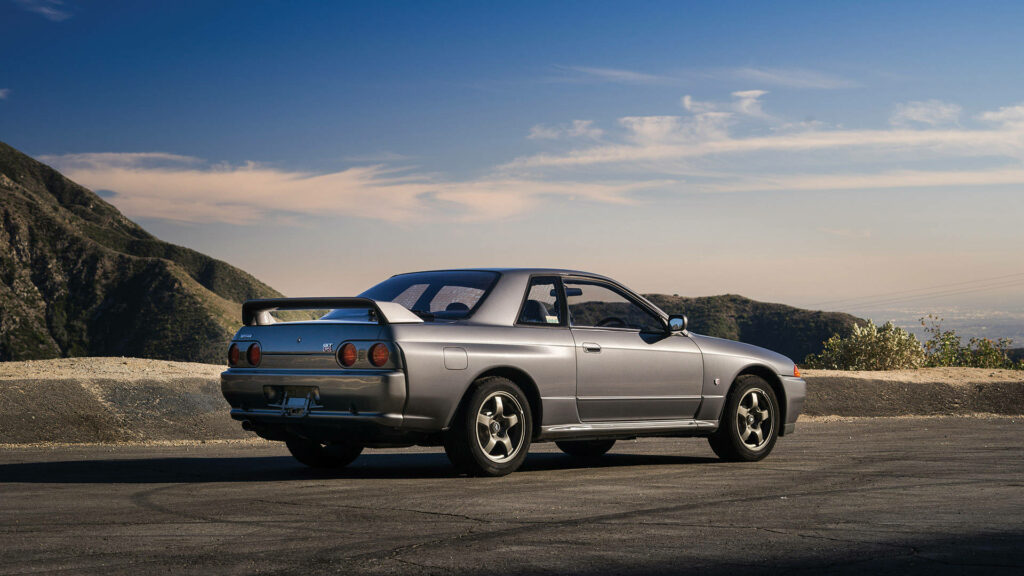 Nissan Skyline R32 Wallpaper: Iconic Car in Serene Mountain Setting