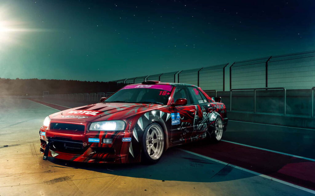 Vibrant Nissan Skyline R33 GTR Wallpaper | Night Racing Track