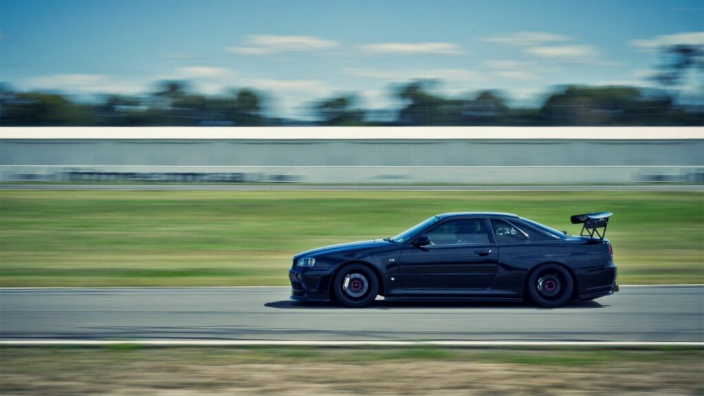 Nissan Skyline R34 Wallpaper: Iconic Speed on the Racetrack