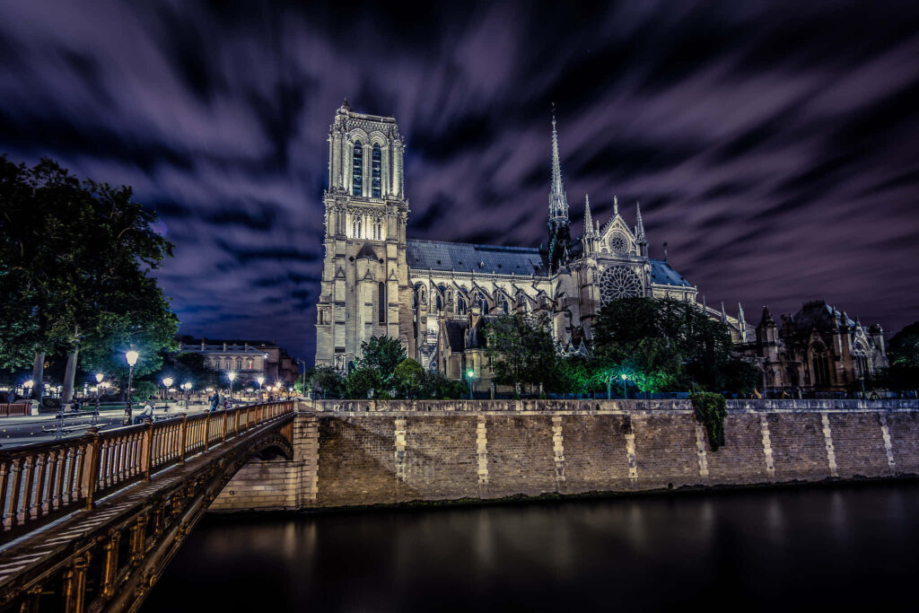 Stunning Notre Dame Cathedral Wallpaper Under Dramatic Clouds