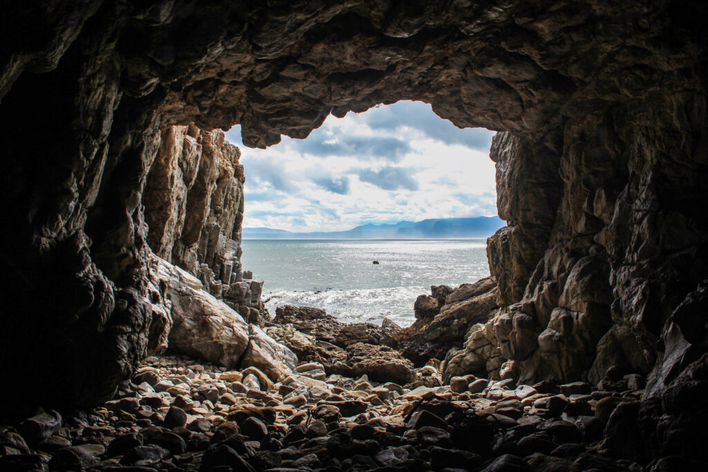 Stunning Ocean View from Rocky Cave Opening - Breathtaking Sunlight Wallpaper