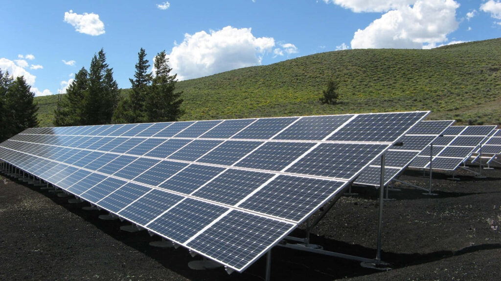 Scenic Solar Panels Off-Grid Wallpaper: Green Hills & Blue Sky