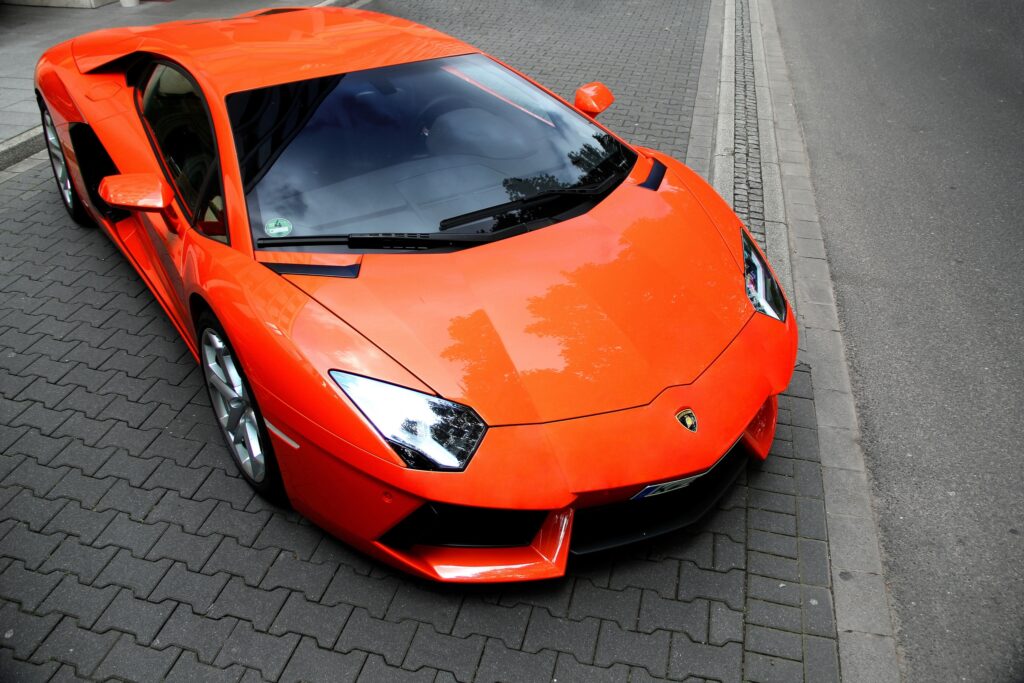 Vibrant Orange Lamborghini Aventador: Urban Supercar Wallpaper