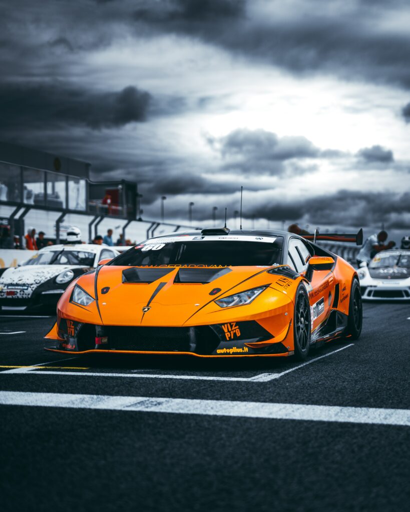 Vibrant Orange Lamborghini Sports Car Racing Wallpaper Background