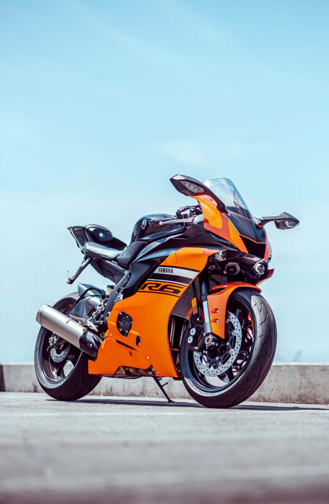 Vibrant Orange Yamaha R6 Wallpaper Against Blue Sky - Speed & Style