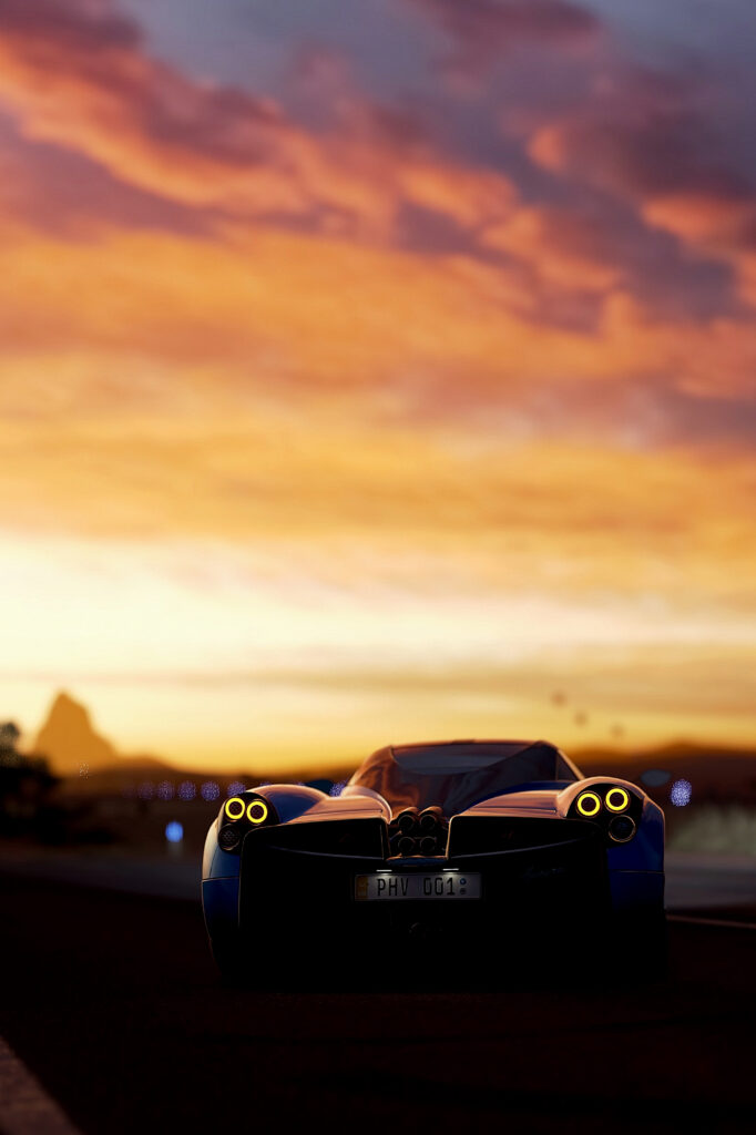 Stunning Pagani Huayra Rear View Against Vibrant Sunset Sky Wallpaper