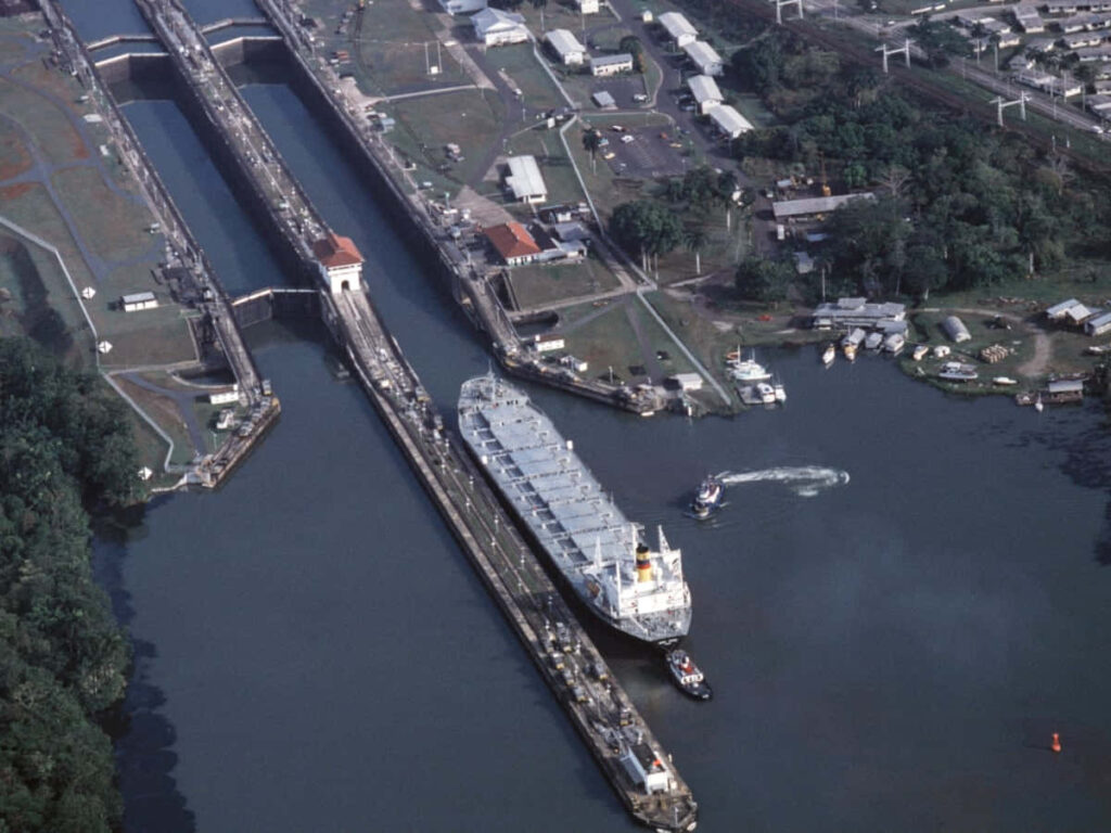 Stunning Panama Canal Aerial View with Ship & Lush Greenery Wallpaper