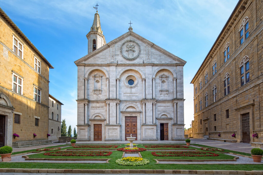 Stunning Pienza Cathedral Wallpaper Against Clear Sky & Gardens