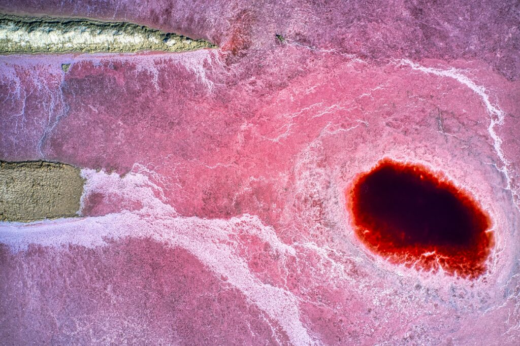 Stunning Aerial Wallpaper: Pink Landscape with Dark Red Crater