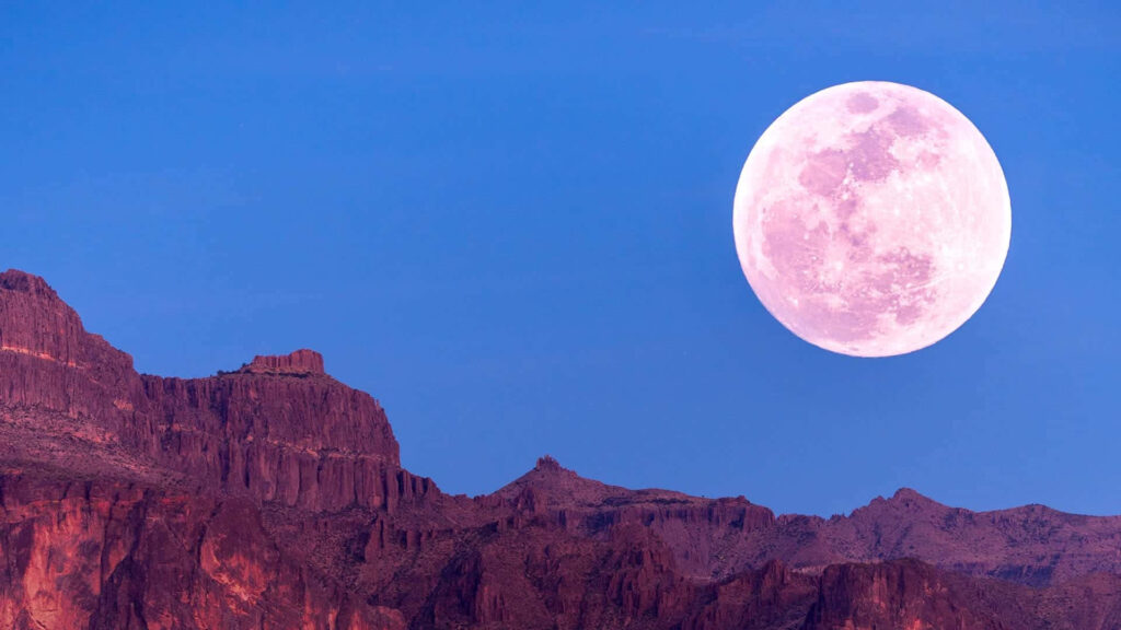 Stunning Pink Moon Wallpaper Over Rugged Mountains & Blue Sky