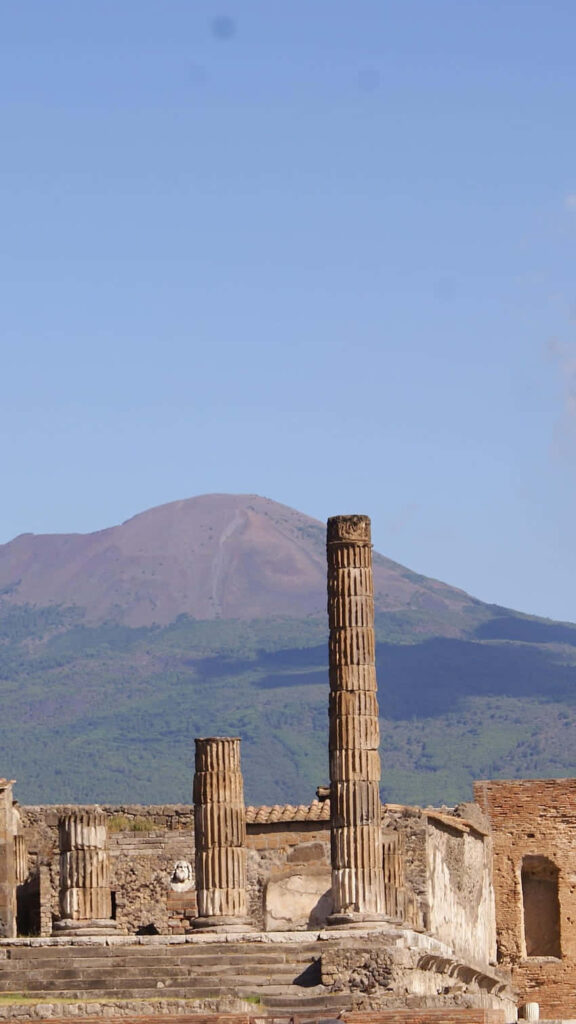 Stunning Pompeii Columns Wallpaper with Mount Vesuvius Background