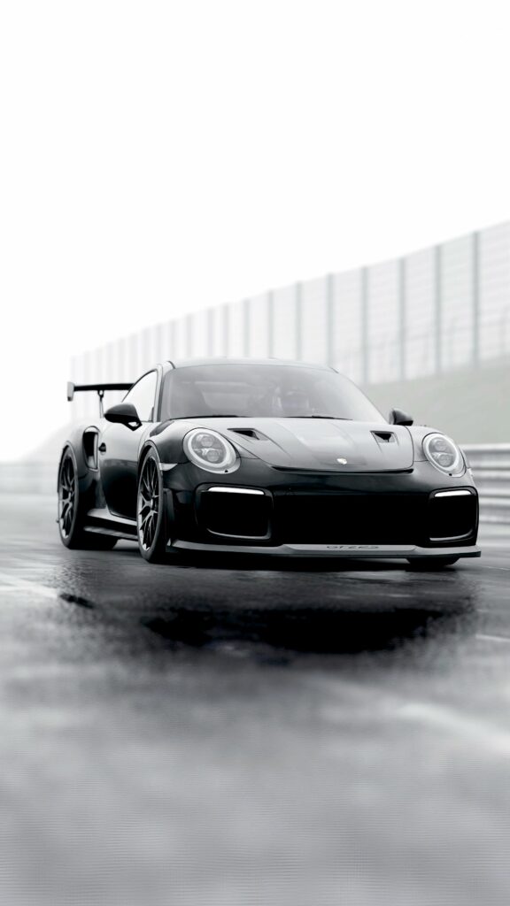 Stunning Black Porsche Supercar Wallpaper on Wet Racetrack