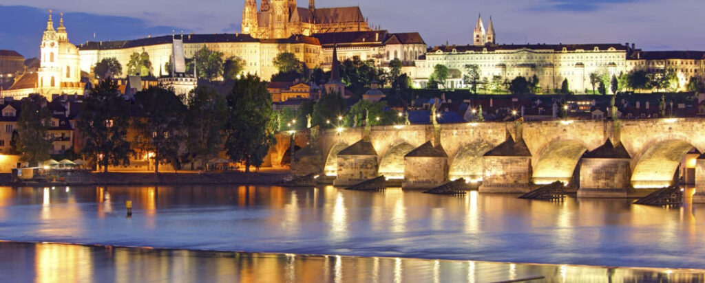 Prague Castle Evening View: Vibrant Lights & Charles Bridge Wallpaper
