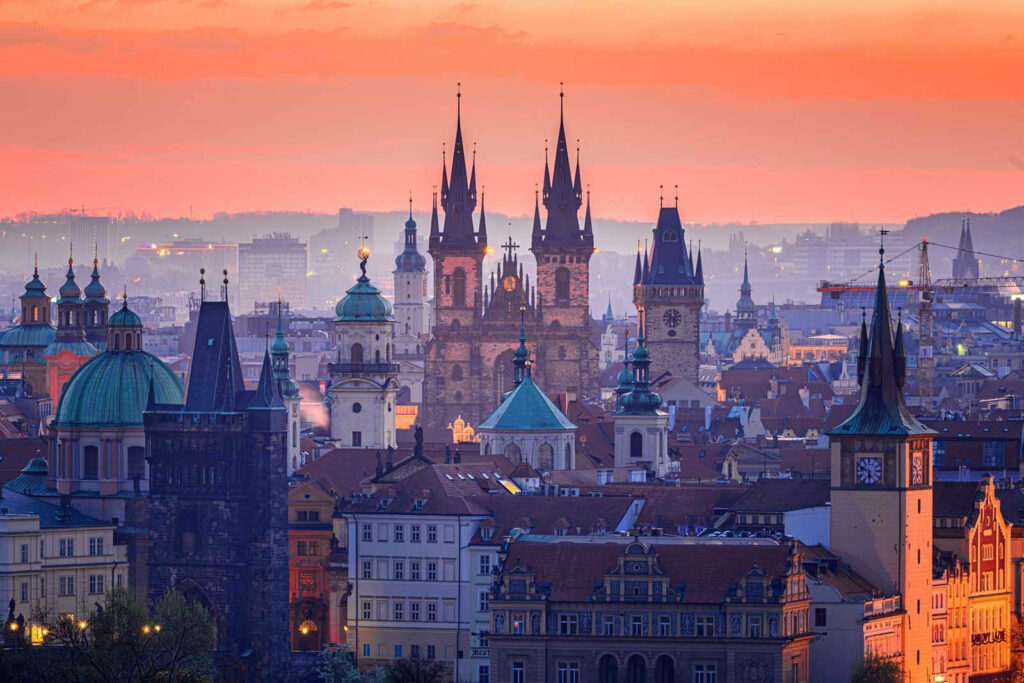 Stunning Prague Skyline Wallpaper: Iconic Churches at Sunset