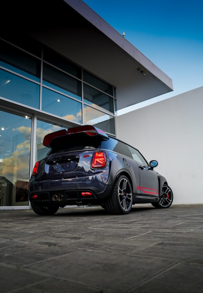 Stunning Purple Mini GP3 on Modern Concrete Pavement Background Wallpaper