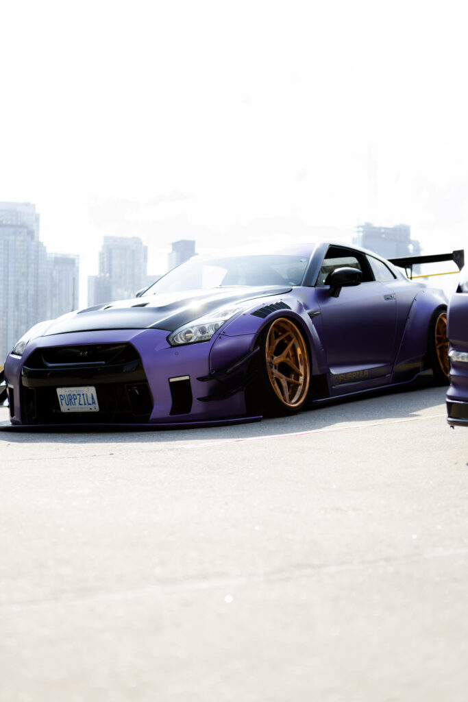 Stunning Purple Nissan Skyline GTR R34 Wallpaper with Golden Wheels