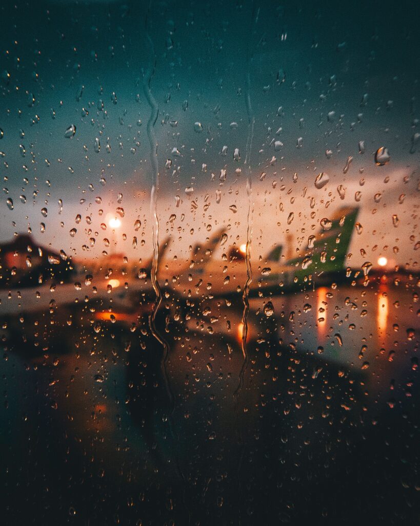 Raindrop Glass Wallpaper: Blurred Plane at Moody Sunset/Sunrise