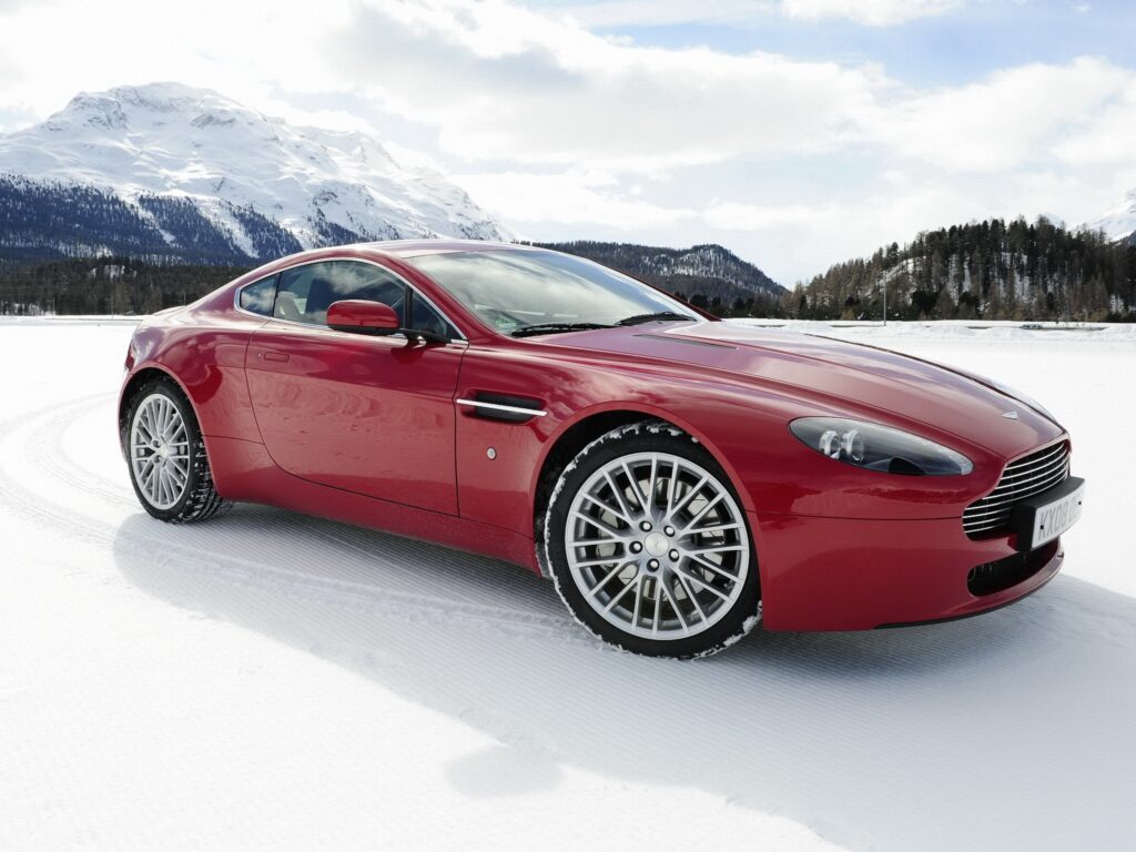 Red 2008 Aston Martin V8 Vantage Wallpaper with Snowy Mountain Background