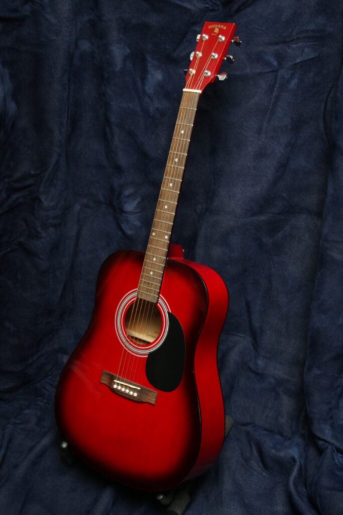 Stunning Red Acoustic Guitar Wallpaper on Deep Blue Fabric Background
