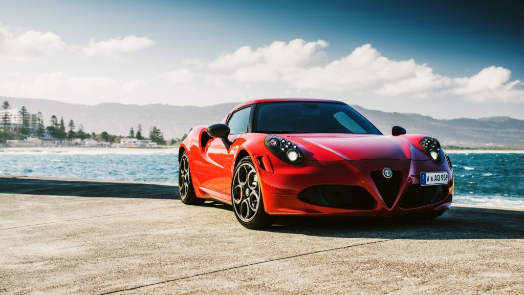Vibrant Red Alfa Romeo 4C: Stunning Coastal Wallpaper