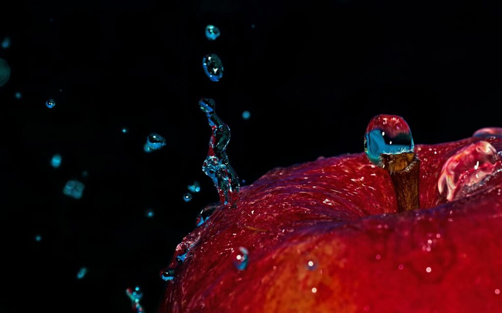 Vibrant Red Apple Close-Up with Water Droplets - Dark Wallpaper
