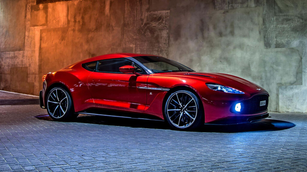 Stunning Red Aston Martin Wallpaper Against Stylish Urban Lights
