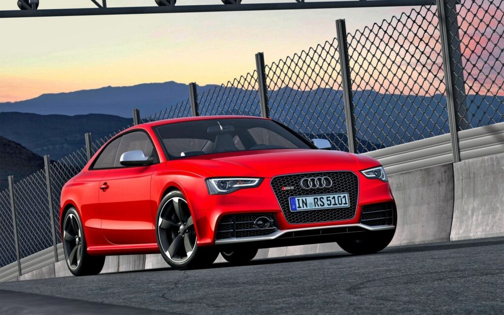 Sleek Red Audi RS5 at Sunset: Mountain Racetrack Wallpaper