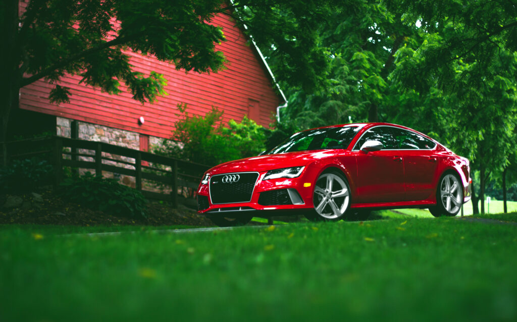 Stunning Red Audi RS7 in Serene Green Landscape Wallpaper