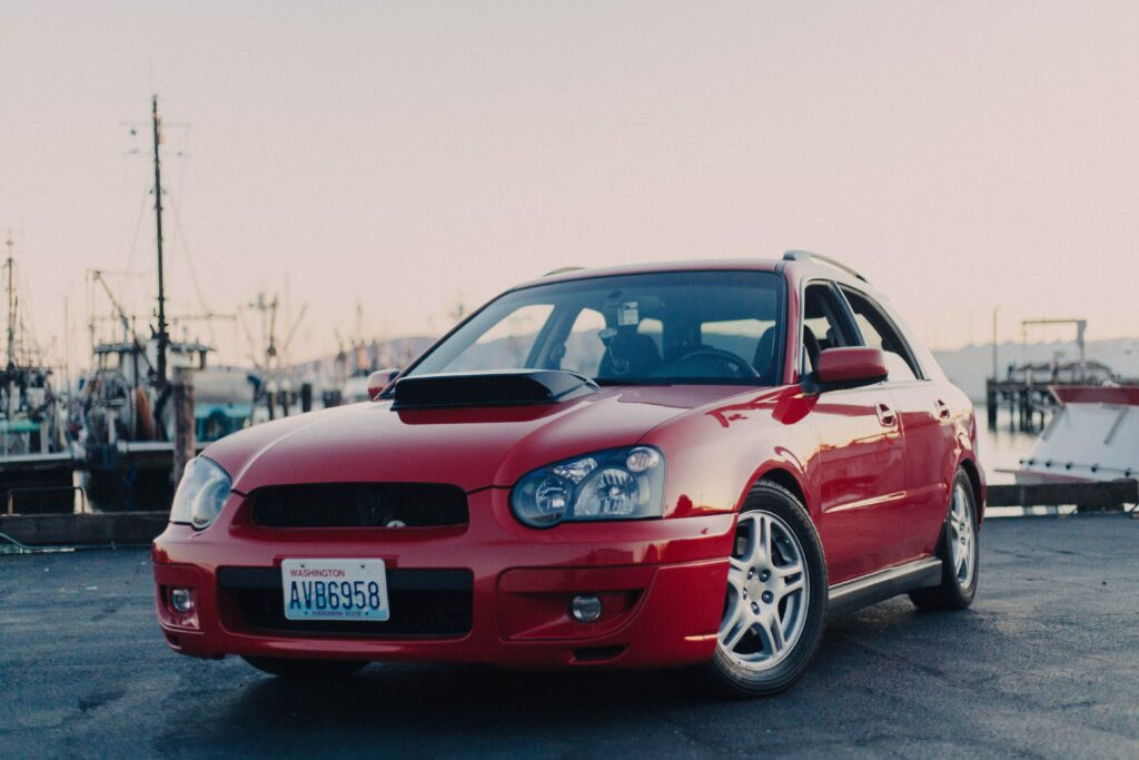 Red Car at Sunset: Stunning Marina Background Wallpaper